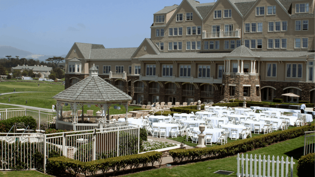Classic resort wedding venue with white gazebo, manicured lawn ceremony setup, and elegant building backdrop for outdoor celebrations