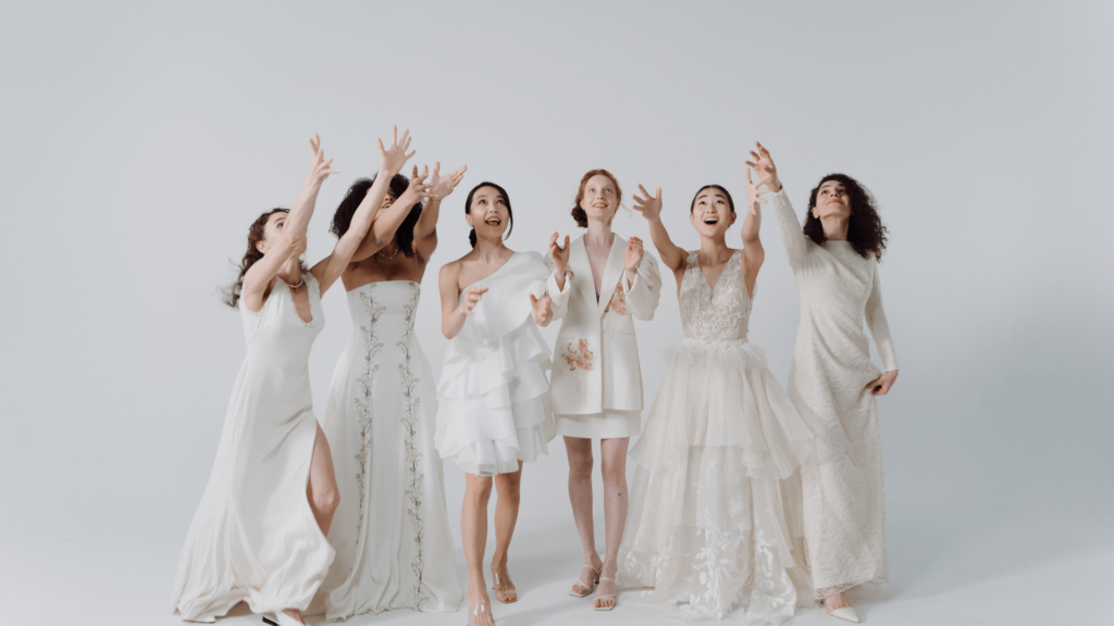 A group of bridesmaids joyfully catching a bouquet, showcasing the success of well-coordinated wedding planning efforts.