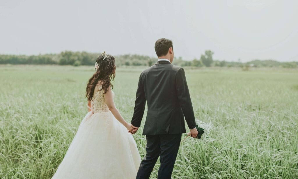 bride and groom in a field