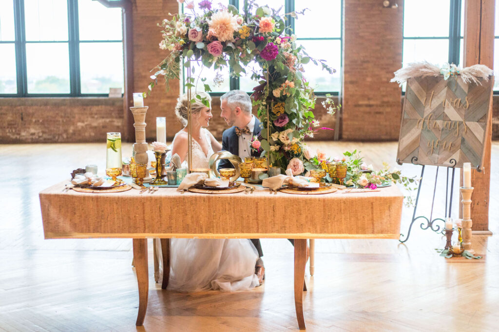 Styled wedding shoot at a Chicago venue with a floral arch and romantic tablescape. Designed by RUSTIQUE SWAN 
