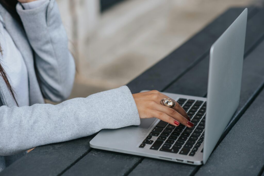 woman working on computer with a wedding ring