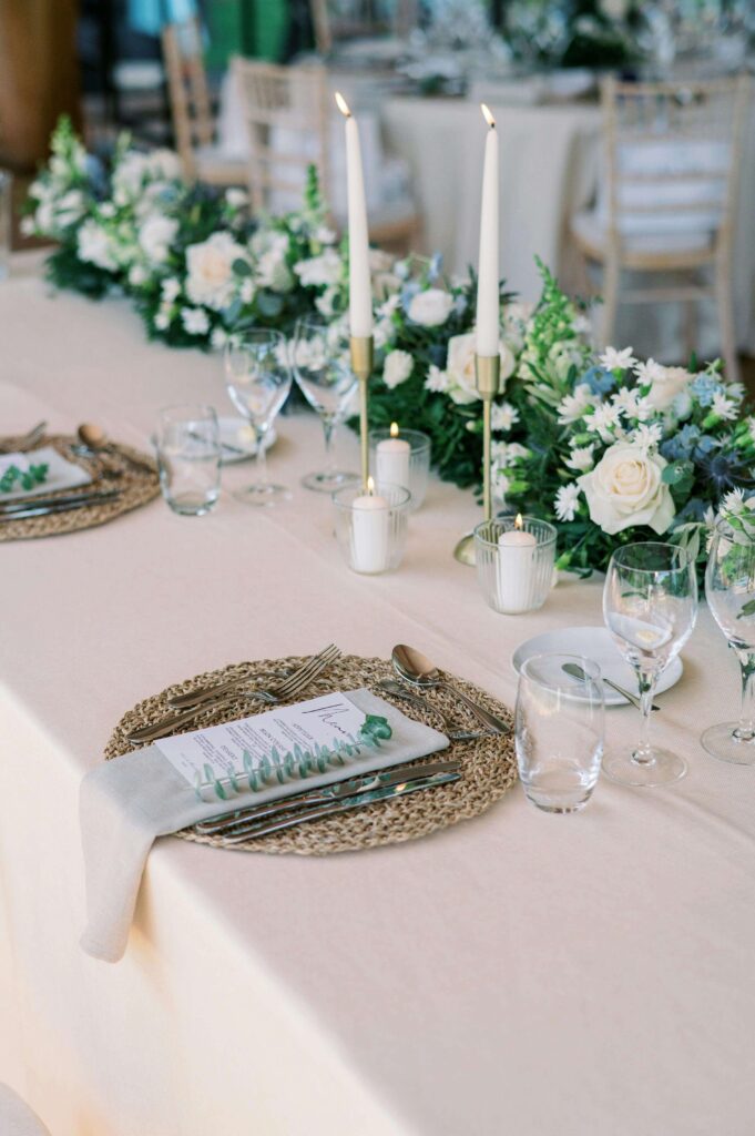 wedding flowers on a table with candles lit