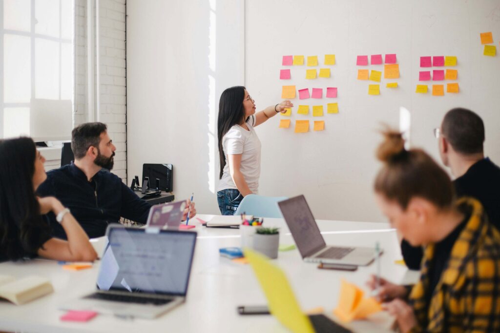 marketing team discussing the calendar and ideas with sticky notes on the wall