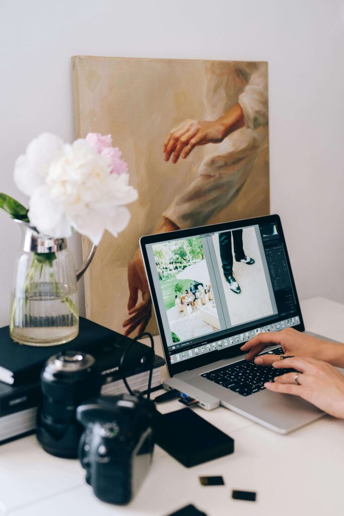 wedding photographer looking through images to make a marketing plan