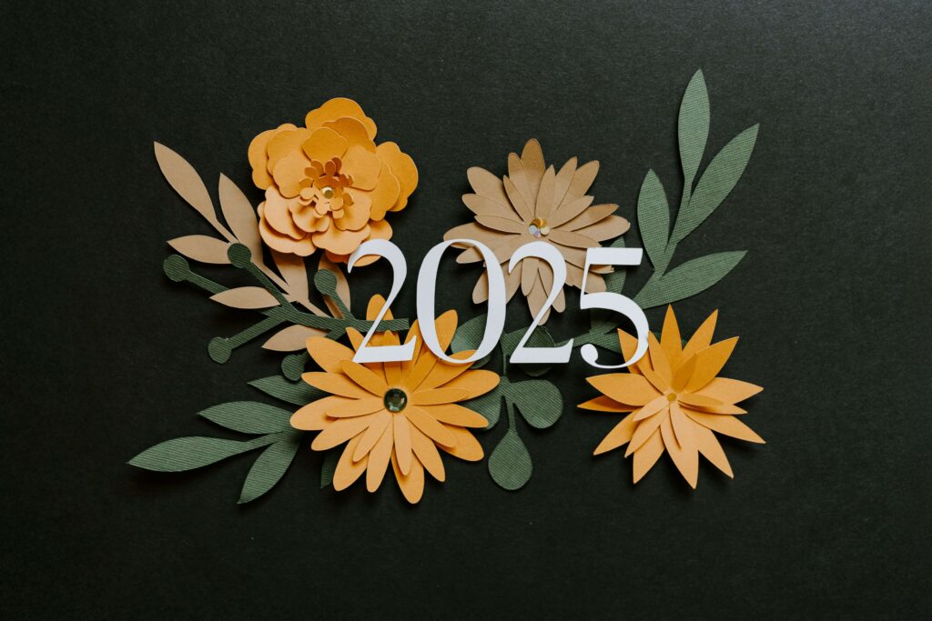 Floral cutout design with the number 2025 on a dark green background, symbolizing a fresh start for the year.