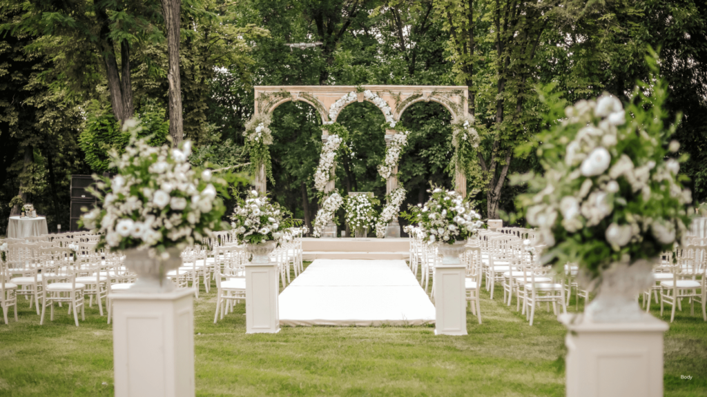 Beautiful wedding ceremony setup with white chairs and floral arrangements, perfect for a memorable outdoor event.