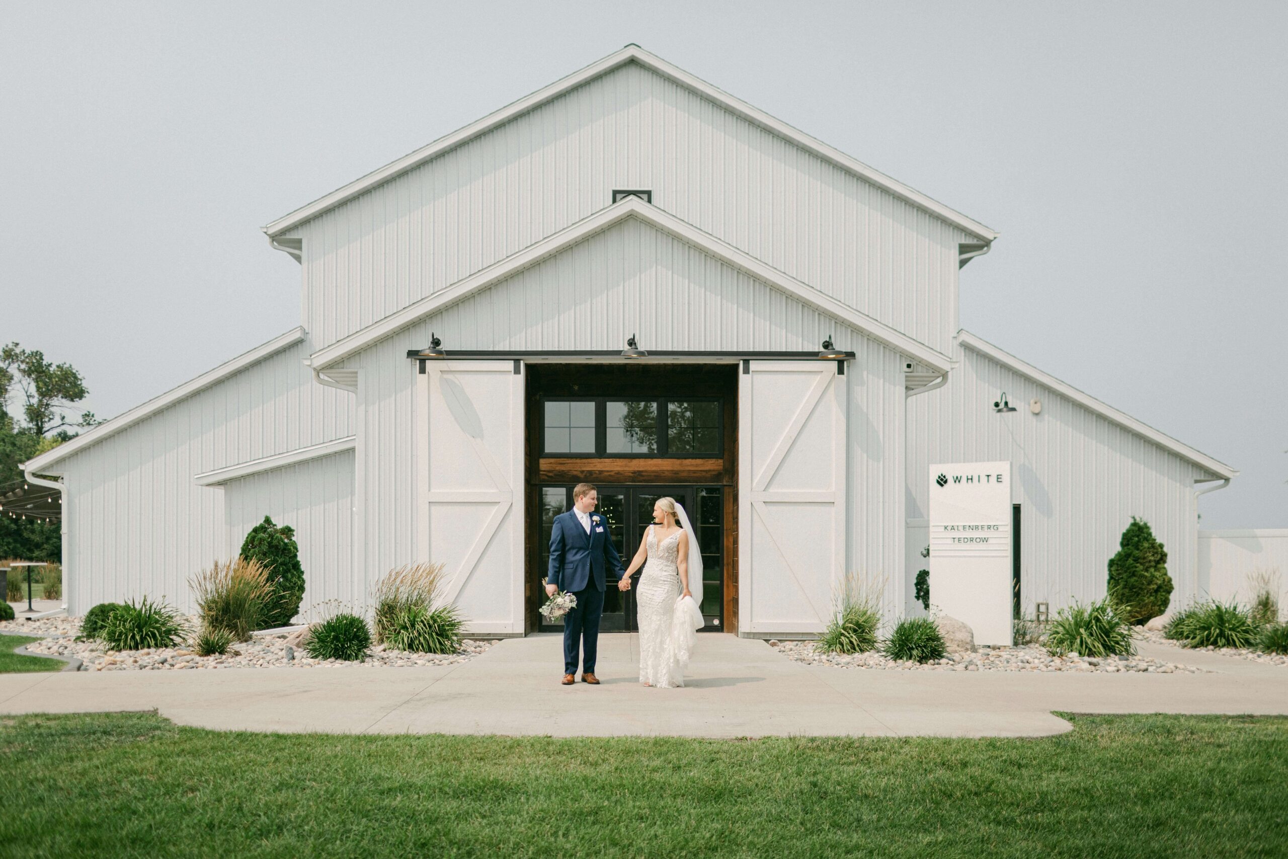 Rustic white barn wedding venue showcasing an elegant setup for a wedding.