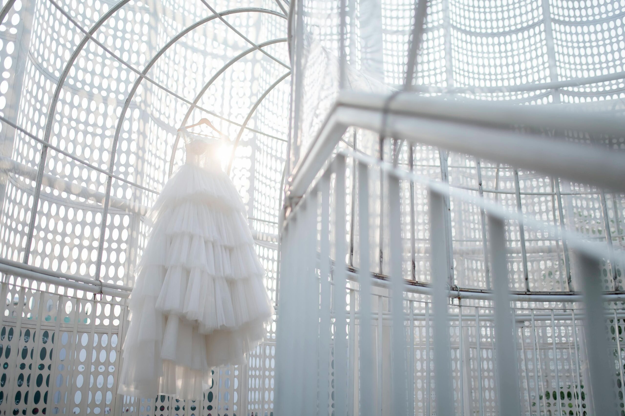 wedding trends wedding dress textural and layers hanging in a modern industrial space