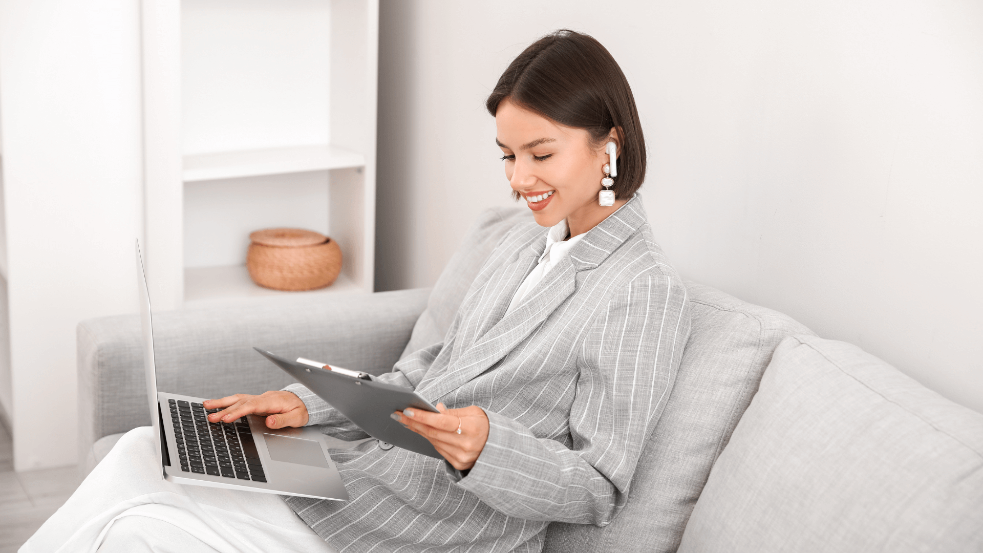 wedding planner working on sofa and reading her marketing plan.