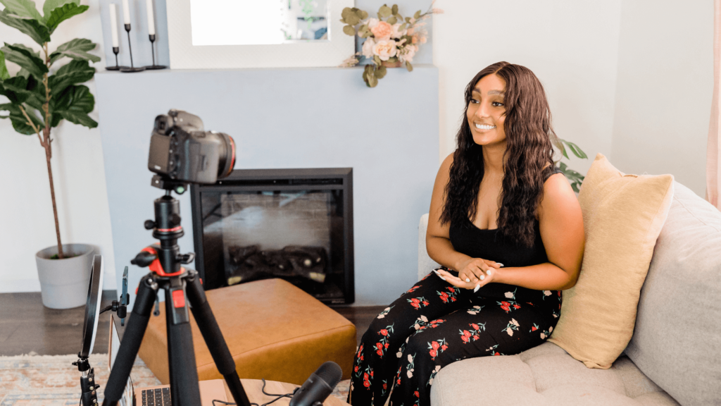 Smiling woman recording a video for social media marketing.