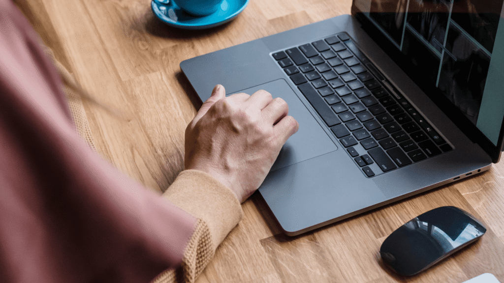 Wedding business owner working on AI Search Optimization strategy from a laptop.