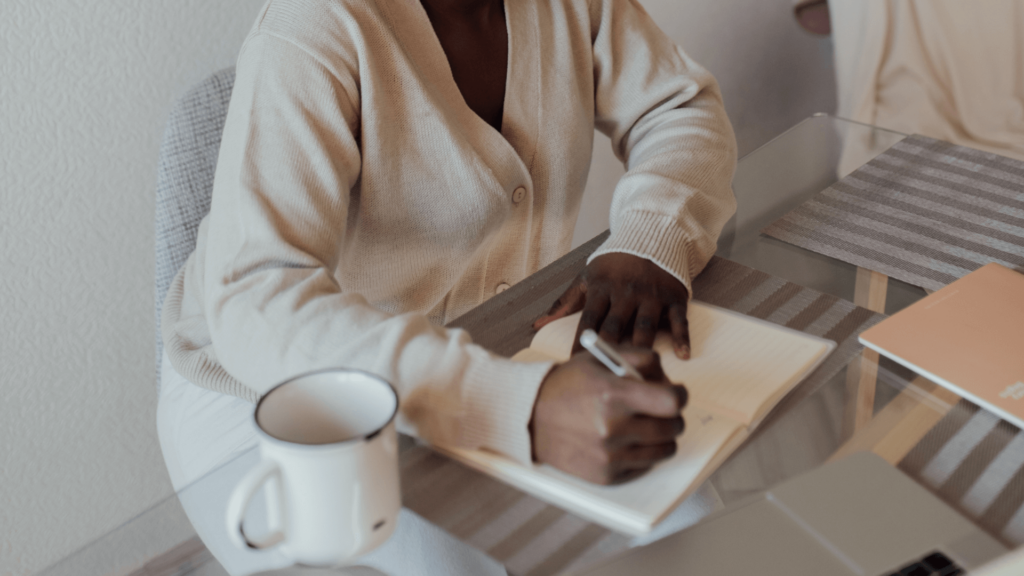 Wedding professional writing out her Pinterest marketing workflow at home