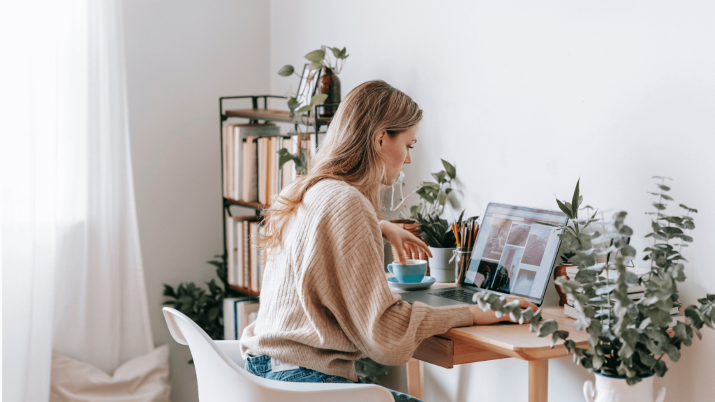 Wedding professional planning Pinterest strategy at her desk with coffee in hand 