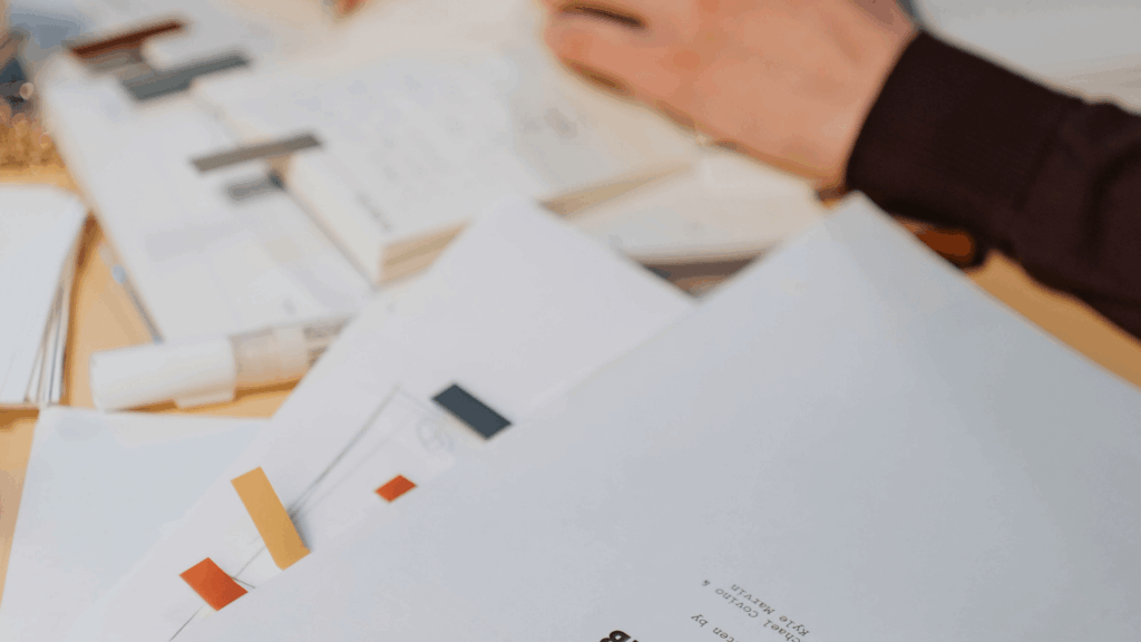 Close-up of papers and swatches during a business systems audit, reviewing workflows and marketing strategies for creative businesses.