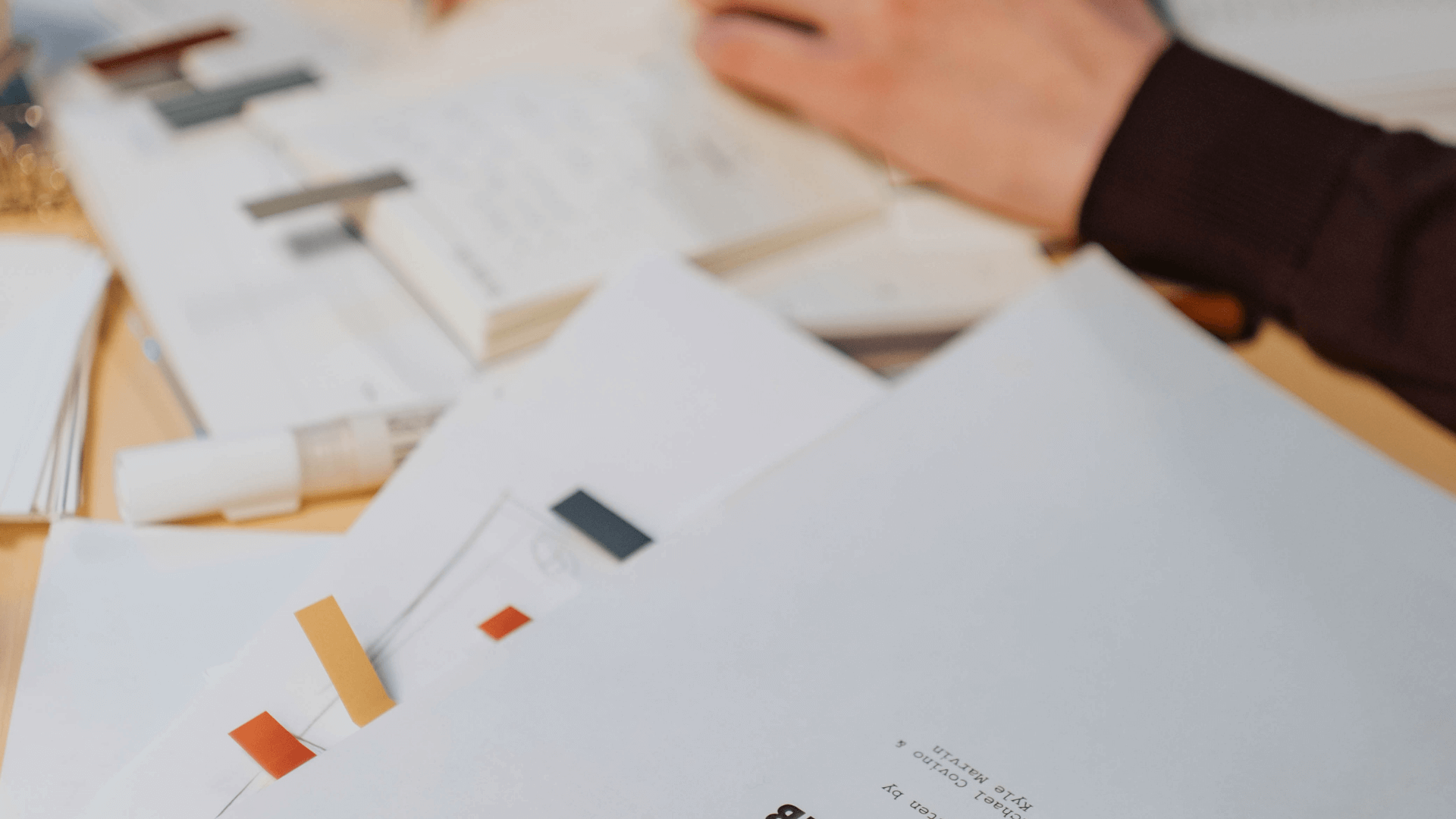 Close-up of papers and swatches during a business systems audit, reviewing workflows and marketing strategies for creative businesses.