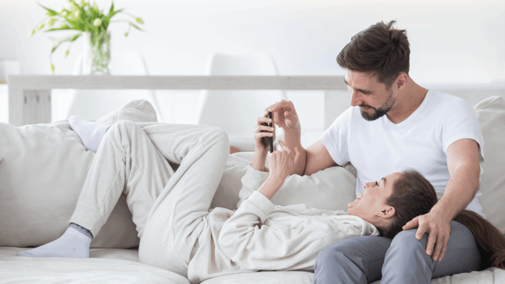 Gen Z couple planning their wedding using a phone for TikTok and Pinterest ideas