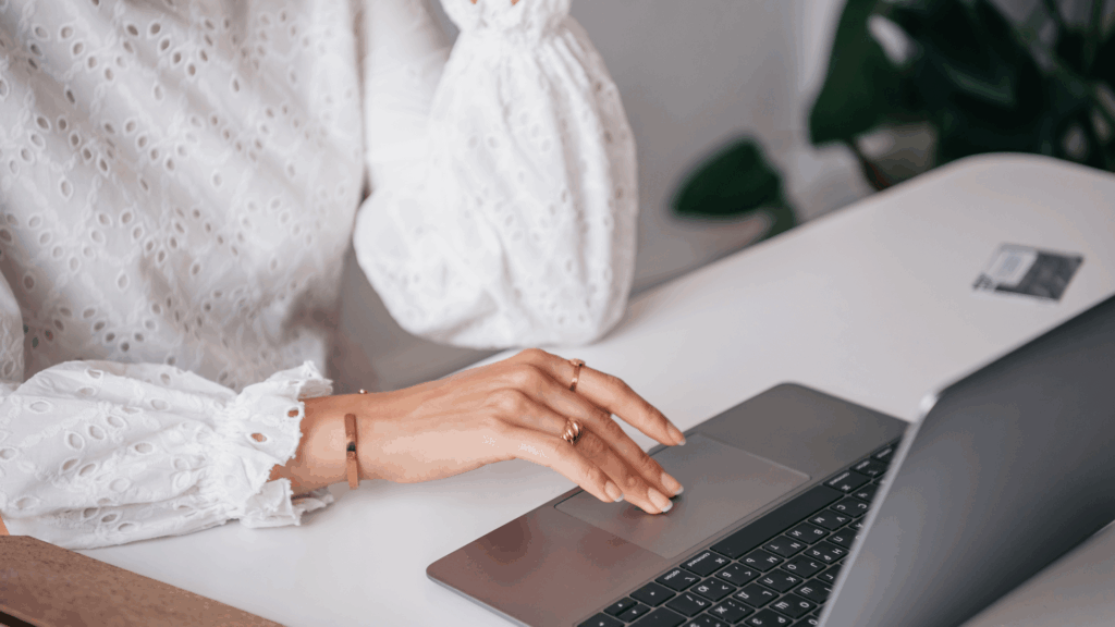 Wedding professional working on a laptop to improve inquiry conversion systems and boost booking rates through marketing audits and client workflows.