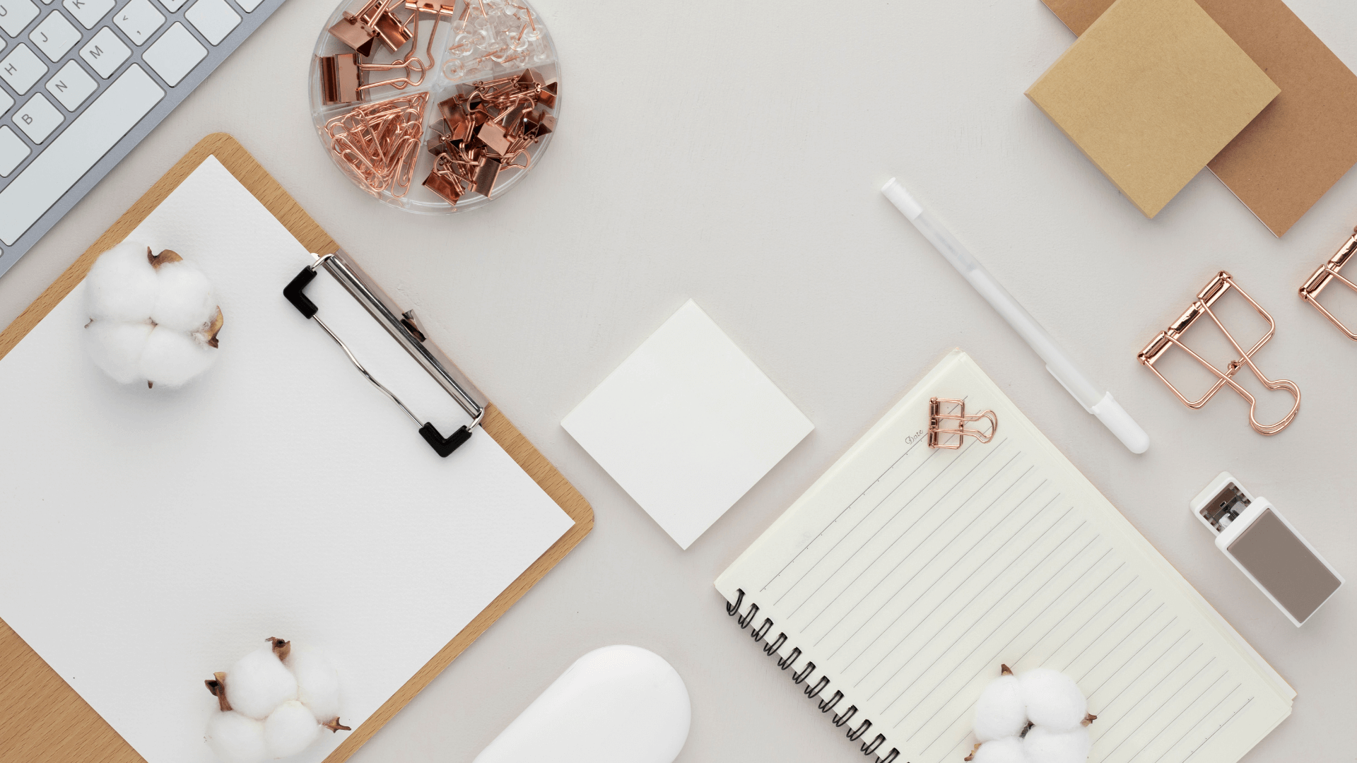 Minimalist flatlay of a laptop, planner, and desk accessories used for reviewing marketing systems and audit checklists.