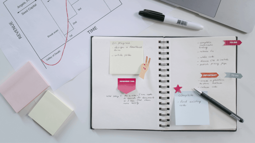 Open notebook with workflow notes and to-do list for building marketing systems and tracking progress