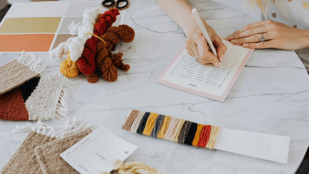 Small business owner creating an email marketing action plan with a handwritten checklist and planning materials.