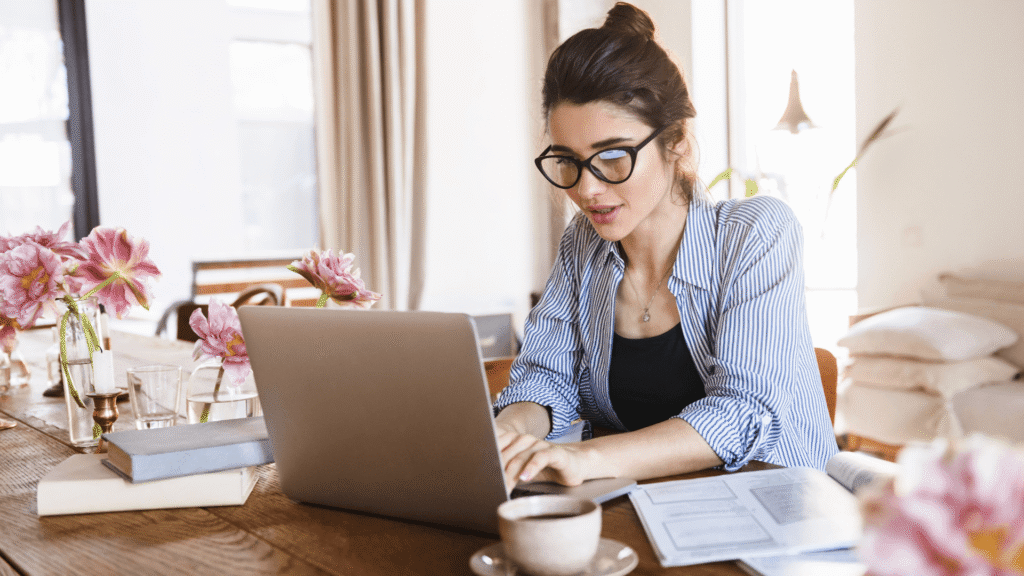 Small business owner building an email marketing system from a laptop at a home office.